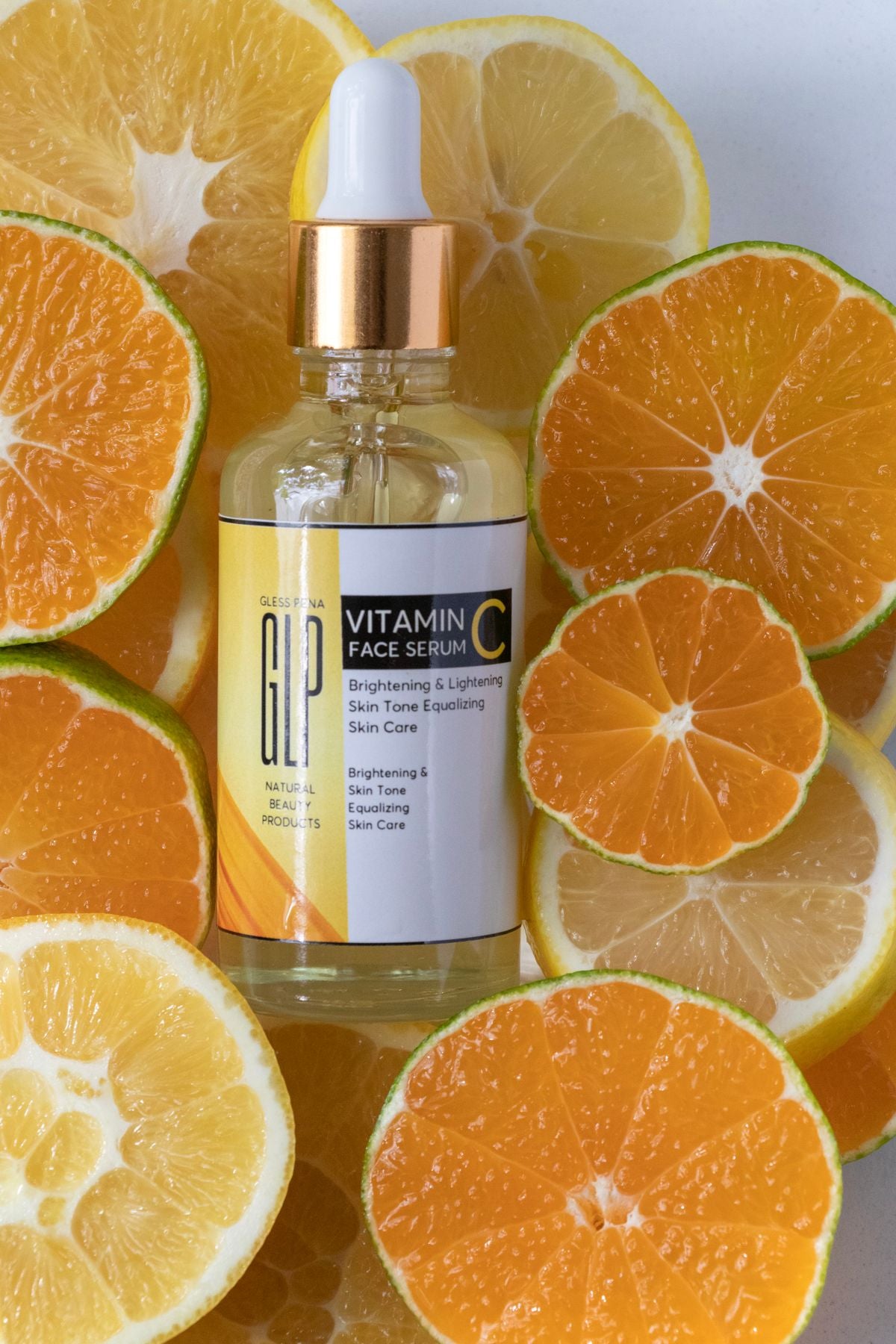 Vitamin C serum bottle surrounded by fresh citrus