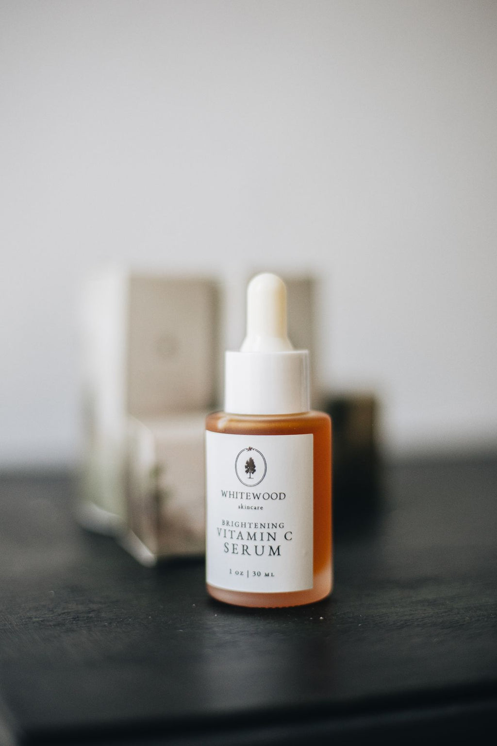 Whitewood brightening vitamin C serum dropper bottle on a dark surface