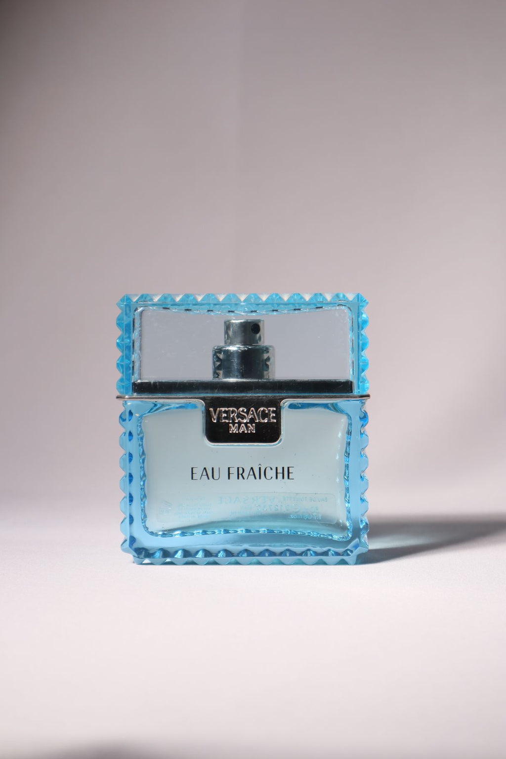 Versace Eau Fraiche perfume bottle isolated on light background