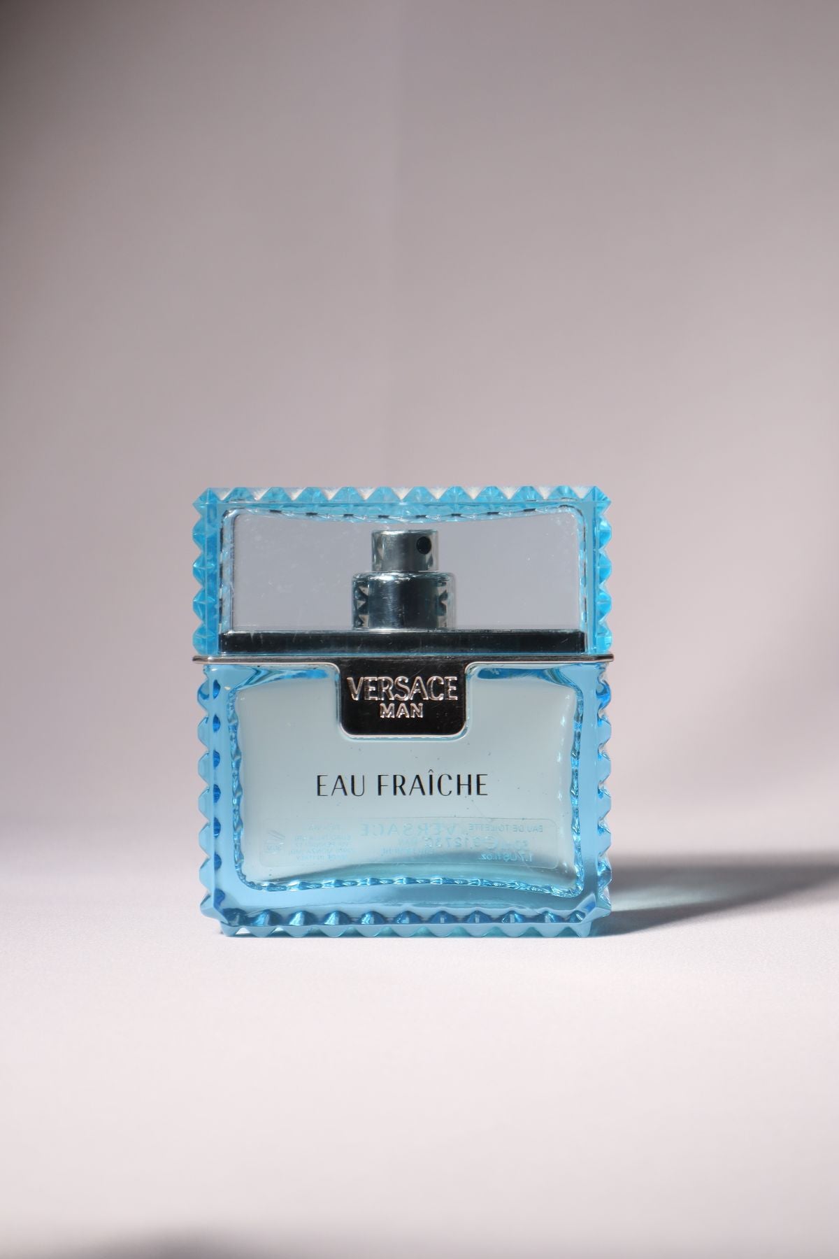 Versace Eau Fraiche perfume bottle isolated on light background