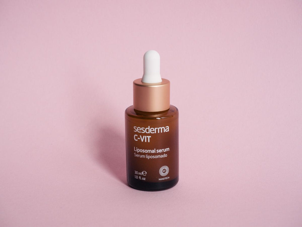 Amber C-VIT liposomal serum dropper bottle on a pink background