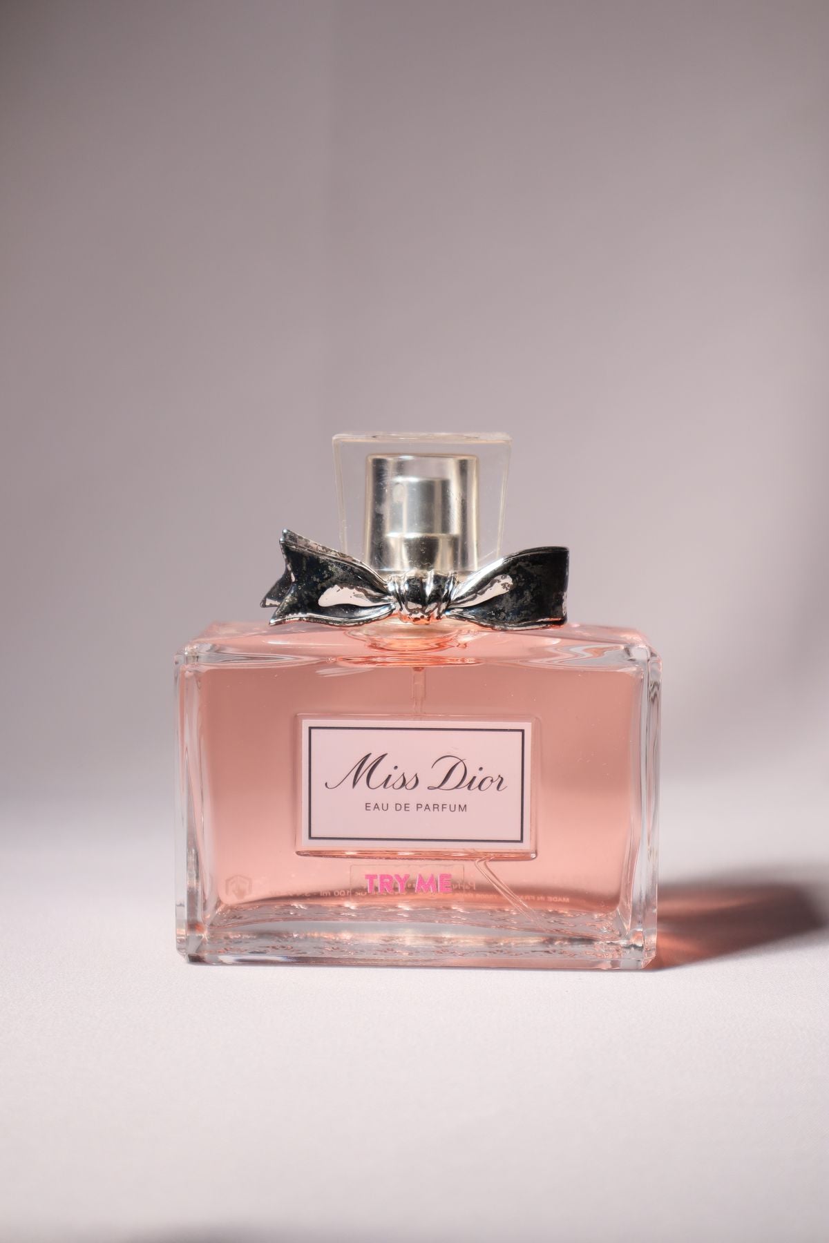 Pink Miss Dior Eau de Parfum bottle with a metallic bow detail at the neck