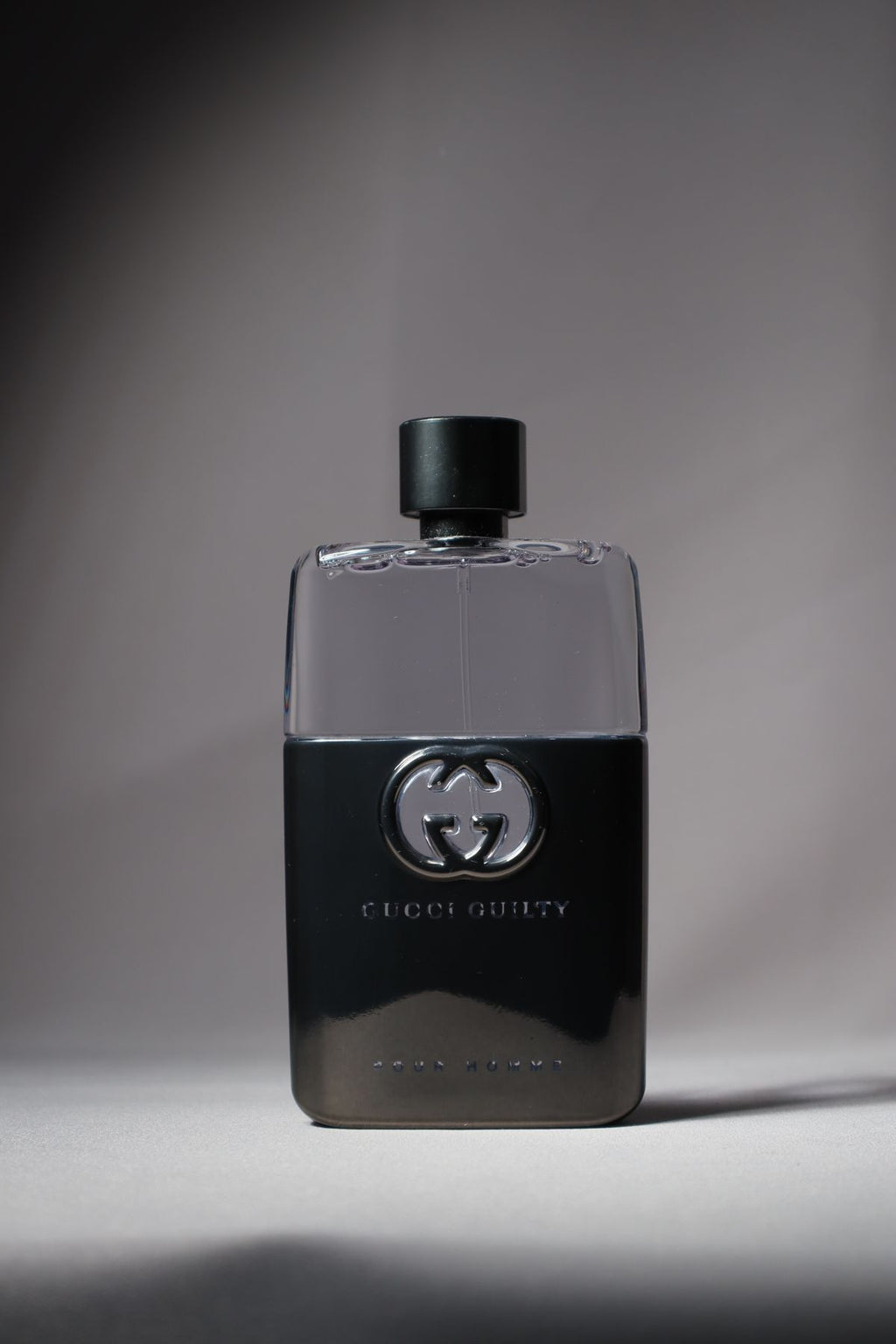 Black Gucci Guilty fragrance bottle with clear upper glass and black cap